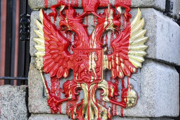 February 24, 2022: Red paint on the coat of arms of the Russian Federation on the gate outside of the Russian Embassy in Dublin, Ireland.