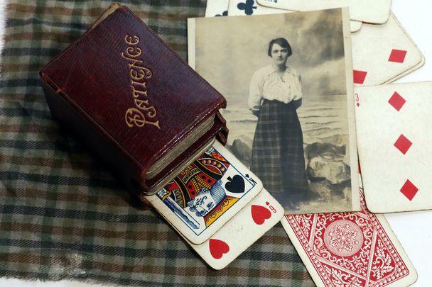 A deck of Patience cards, a chequered handkerchief and a postcard belonging to British lawyer, suffragette, political activist and former Titanic survivor, Elise Bowerman. 