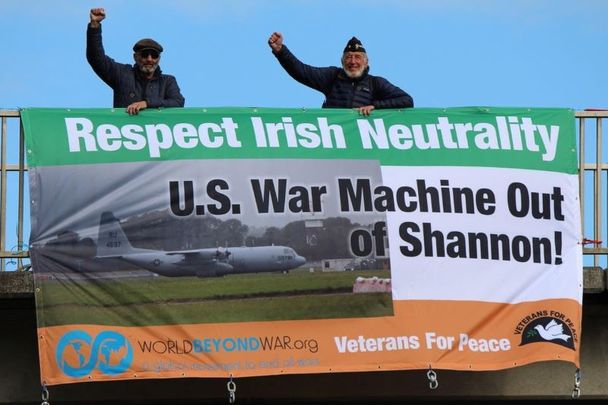 US military veterns Ken Mayers and Tarak Kauff with a \"Respect Irish Neutrality\" banner.