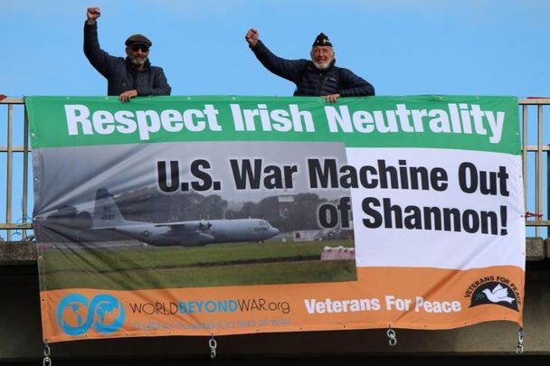 US military veterans Ken Mayers and Tarak Kauff with a \"Respect Irish Neutrality\" banner.