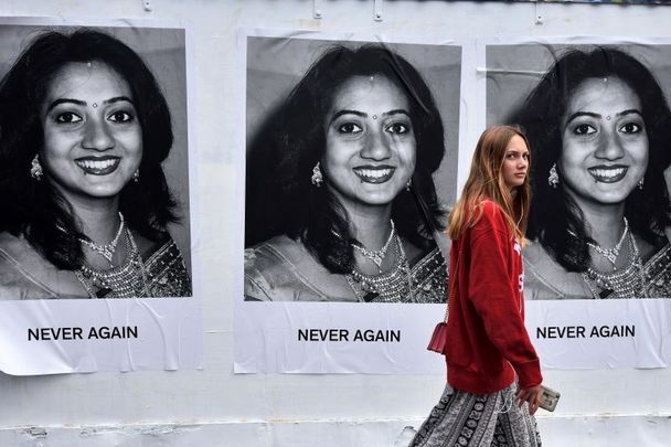 May 26, 2018: A woman walks past artwork featuring Savita Halappanavar which states \'Never Again\' as the results in the Irish referendum on the 8th amendment concerning the country\'s abortion laws takes place at Dublin Castle in Dublin, Ireland.