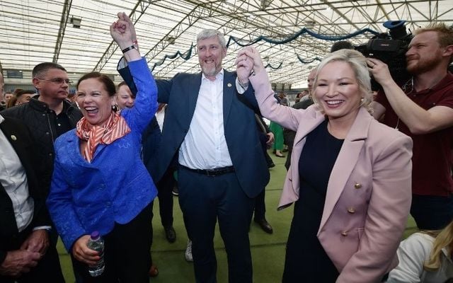 Sinn Féin northern leader Michelle O\'Neill (R) and Sinn Féin leader Mary Lou McDonald celebrate with party candidate John O\'Dowd after he was elected in Northern Ireland\'s Election