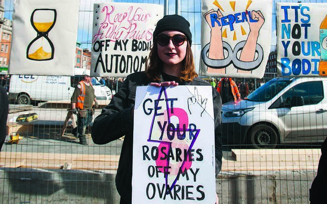 \"Keep your rosaries off my ovaries\": A Repeal the 8th Amendment protester.