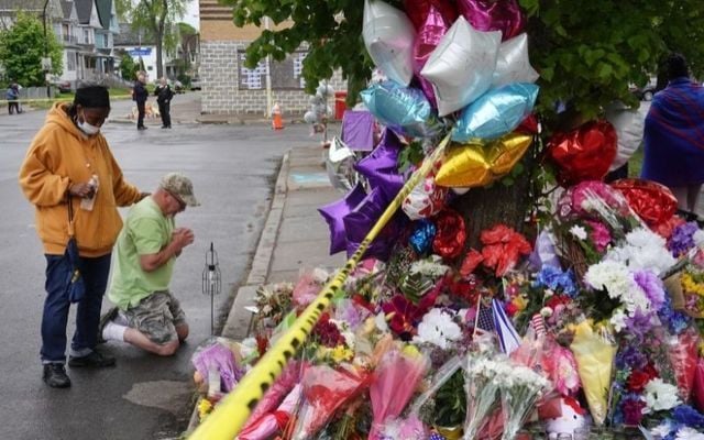 MAY 18: People visit a makeshift memorial set up outside the Tops supermarket on May 18, 2022, in Buffalo, New York.