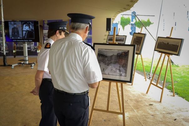 Garda Commissioner Drew Harris admires photos from the Garda Centenary Online Photographic Archive.