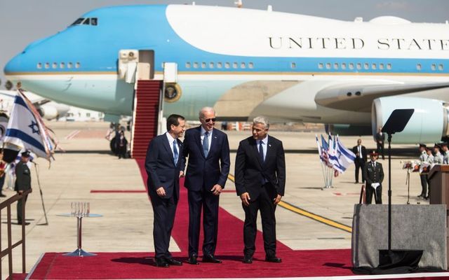 U.S. President Joe Biden is welcomed by Israeli Prime Minister Yair Lapid and Israeli President Isaac Herzog during an arrival ceremony at Ben Gurion Airport on July 13, 2022 in Lod, Israel.