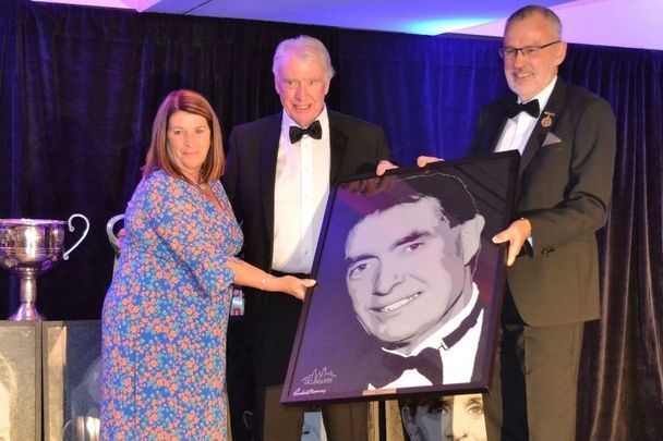 New York GAA Chairperson Joan Henchy, Mike Carty and GAA President Larry McCarthy, with a presentation of a picture of Carty drawn by a local artist.