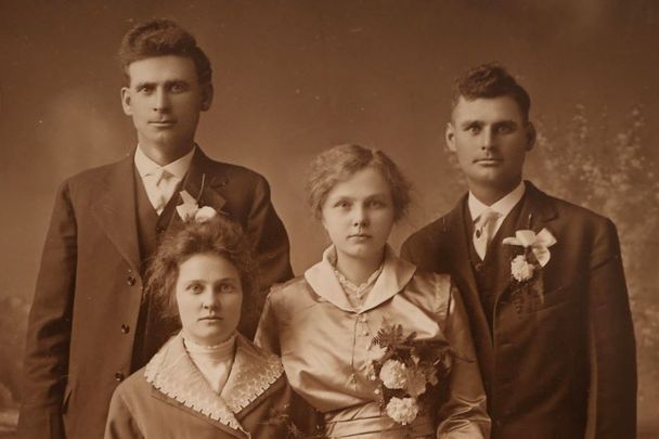 A formal wedding photograph of Mary Jannet “Jennie” Foley Walsh, left seated, with husband Martin J. Walsh Sr., Murdock, Minnesota, standing left. They are joined by Mary Ann “Maime” Foley Walsh, sister of the bride, and Henry L. Walsh, brother of the bride. The wedding was Nov, 4, 1915, Sacred Heart Catholic Church, Murdock, Minnesota. Mary Ann and Henry married Jan. 8, 1919. The children of the two couples became double first cousins, meaning the cousins share two sets of grandparents, Foley and Walsh, instead of one set of grandparents.