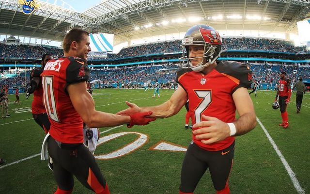 Patrick Murray #7 and Adam Humphries #10 of the Tampa Bay Buccaneers after the win against the Miami Dolphins at Hard Rock Stadium on November 19, 2017, in Miami Gardens, Florida.