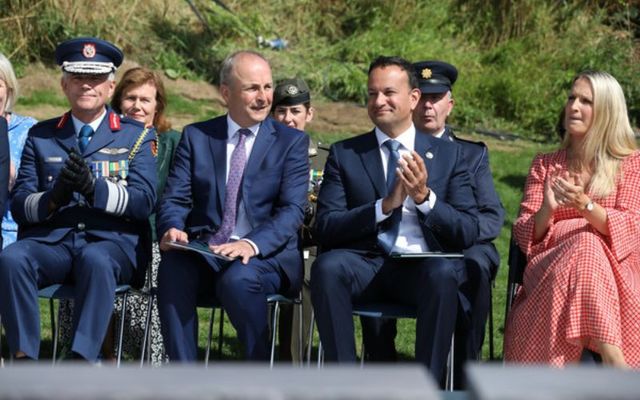 Fianna Fáil\'s Micheál Martin (left) and Fine Gael\'s Leo Varadkar (right) sit side by side at a ceremony honoring the 100th anniversary of the death of Michael Collins in Béal na Bláth, County Cork. 
