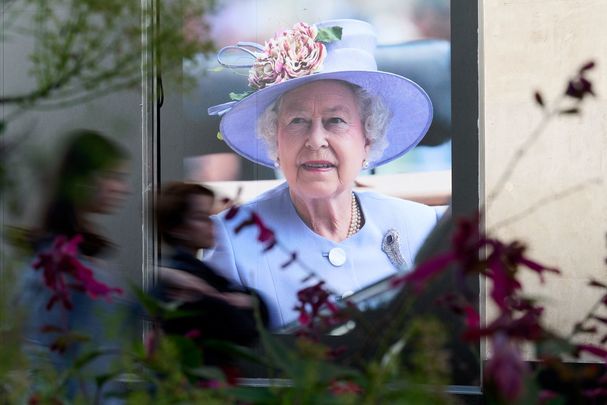 A photo of Queen Elizabeth hanging in a shop front on Oxford Street, in London.