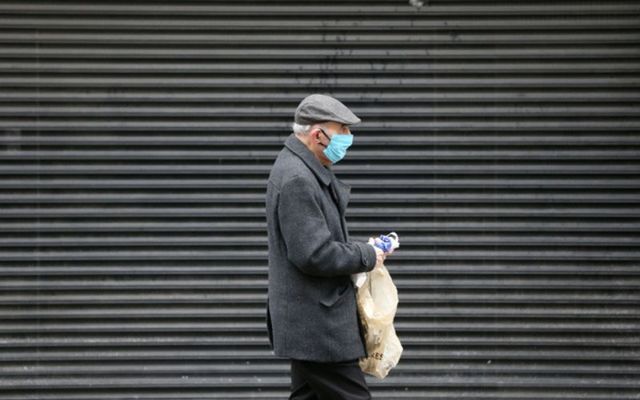 An elderly pensioner walks through Dublin in February 2021. 