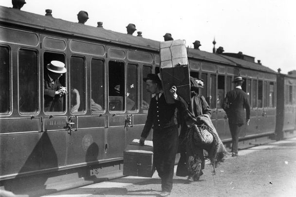 September 25, 1911: A porter carrying luggage at Kingsbridge Station, Ireland. 