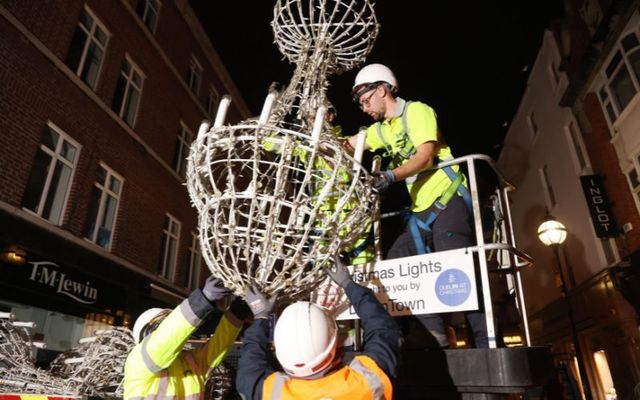 Workers erect Christmas Lights on South Anne Street. 