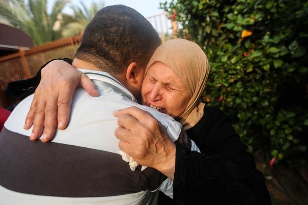 People mourn as they collect the bodies of Palestinians killed in Israeli air raids, on October 24, 2023 in Khan Yunis, Gaza. 