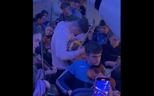 Members of the Cavan Town branch of Comhaltas Ceoltóirí Éireann performing on a delayed Aer Lingus flight.