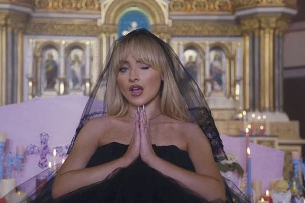 A still from Sabrina Carpenter\'s video for \"Feather\" filmed in the Annunciation of the Blessed Virgin Mary Church in Brooklyn, New York.