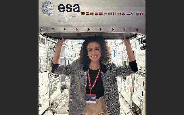 SpaceFest speaker Fionnghuala O’Reilley at ESTEC, ESA’s European Space Research and Technology Centre, where she poses in front of a model of a module from the International Space Station. 