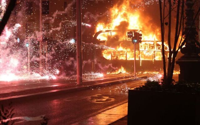 November 23, 2023:  A double-decker bus and a car set alight on the edge of Dublin\'s O\'Connell Bridge people riot on O\'Connell Street and surrounding areas of Dublin City Center.