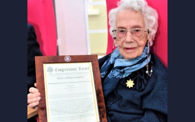 Maureen Sweeney displays her special US House of Representatives honor, received in 2021 for her role in the D-Day landings. 