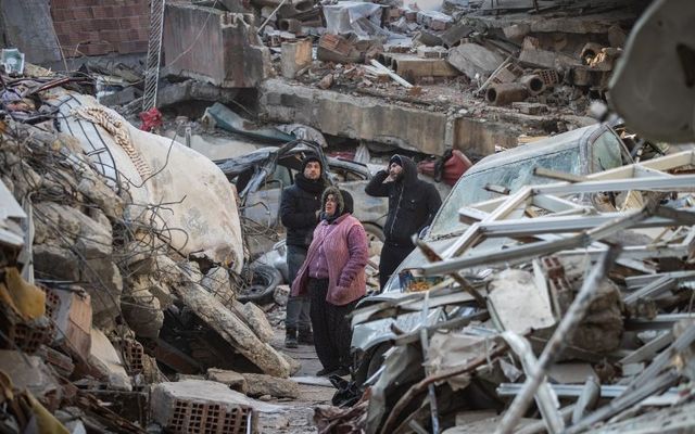  People wait for news of their loved ones, believed to be trapped under a collapsed building on February 11, 2023, in Hatay, Turkey. 