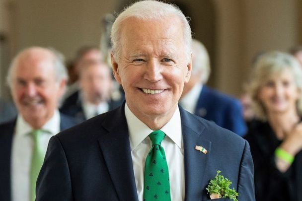 President Joe Biden, photographed during the 2022 St. Patrick\'s Day celebrations, wearing the traditional shamrock in his lapel.