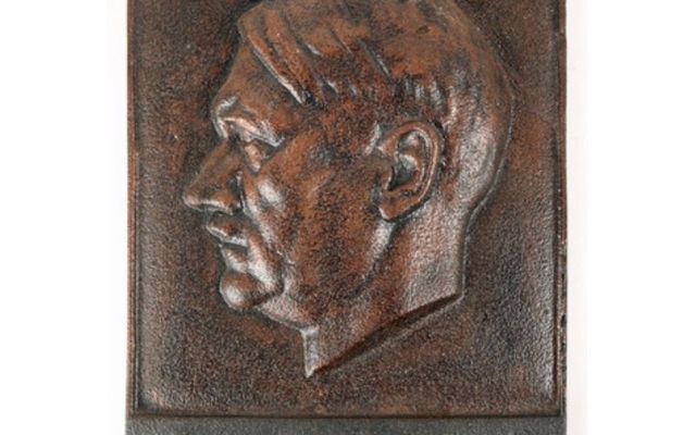 A cast-iron plaque of Adolf Hitler available at Saturday\'s auction. 