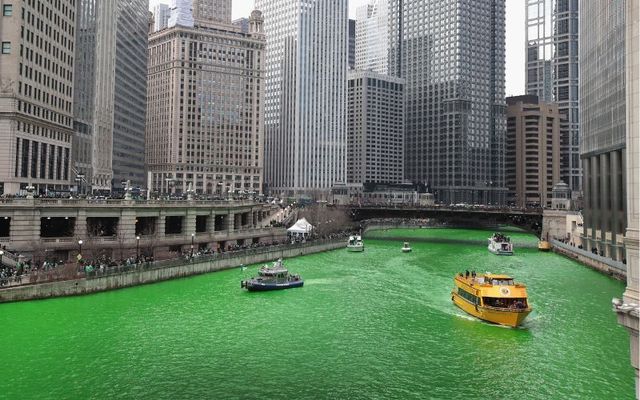 March 17, 2018: Boats navigate the Chicago River shortly after it was dyed green in celebration of St. Patrick\'s Day in Chicago, Illinois. Dyeing the river has been a St. Patrick\'s Day tradition in the city since 1962.