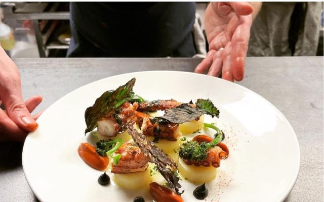 A chef serves an Octopus a la Plancha dish at Uno Mas in Dublin. 