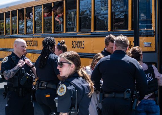 School buses with children arrive at Woodmont Baptist Church to be reunited with their families after a mass shooting at The Covenant School on March 27, 2023 in Nashville, Tennessee