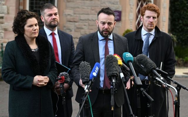 SDLP leader Colum Eastwood (center-right) addresses the media in February 2023. 