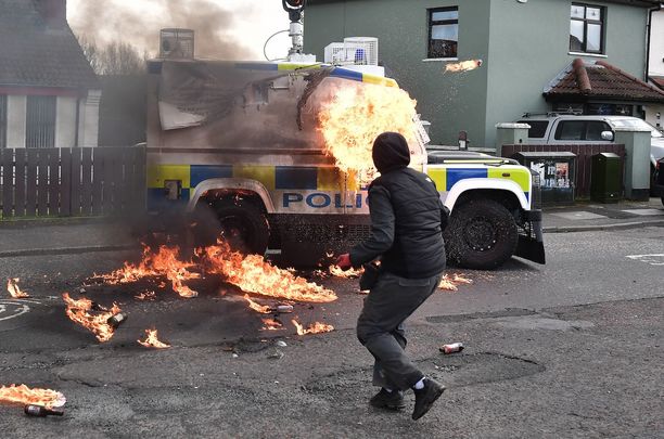 Masked men throw petrol bombs at a police Land Rover during a republican Easter Parade in Derry the day before President Joe Biden arrives to Northern Ireland to celebrate historic peace.