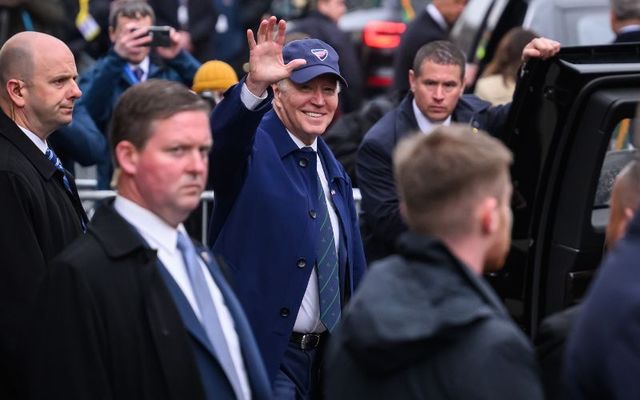 Joe Biden waves to members of the public after arriving in Dundalk on Wednesday evening. 