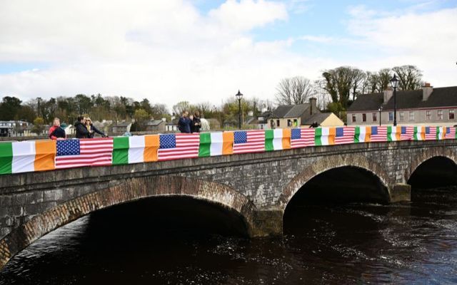 April 14, 2023: A row of American and Irish flags is displayed on a bridge over the River Moy prior to the arrival of US President Joe Biden for a celebration event outside St Muredach\'s Cathedral, in Ballina, Co Mayo, Ireland. 