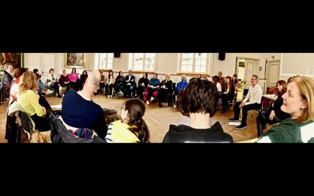 Celebrating Women with Words at the CCI Paris - President Desmond McGetrick in white jumper on the right, Róisín Dockery, jury chair in green in the foreground