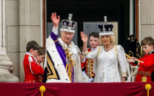King Charles III waves from the Buckingham Palace balcony during the Coronation of King Charles III and Queen Camilla on May 06, 2023 in London, England.