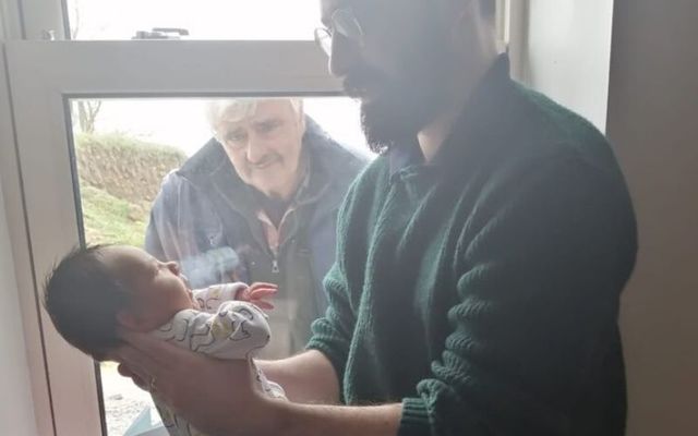 Photograph of Irish grandfather meeting grandson through window included in Netflix doc