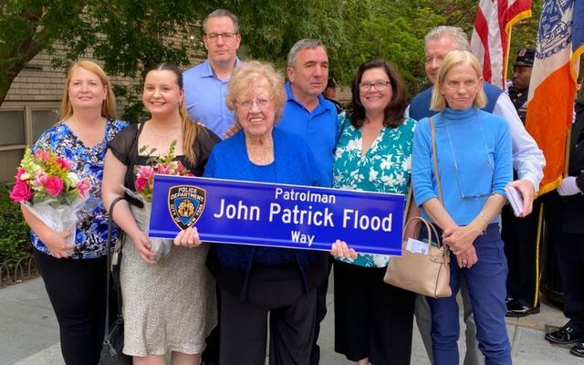 May 12, 2023: Maureen O\'Grady holds her grandfather\'s street sign at 77th and York Ave in New York City.