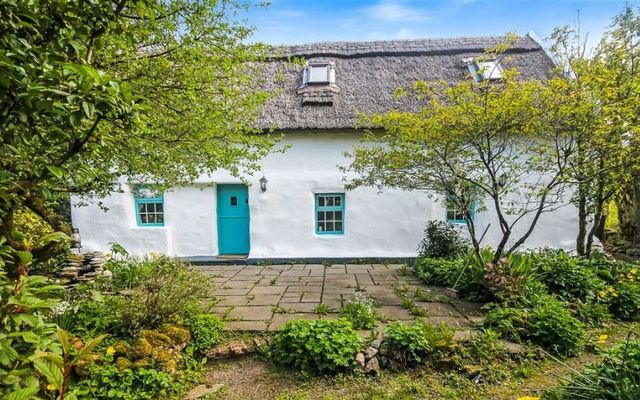 Irish thatched cottage in foothills of Wicklow Mountains 