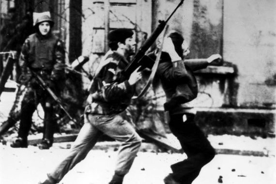January 30, 1972: An armed soldier attacks a protestor on Bloody Sunday when British Paratroopers shot dead 13 civilians on a civil rights march in Derry City. 