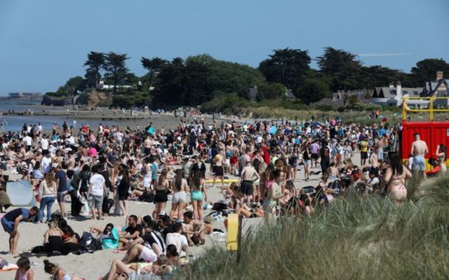 June 5, 2023: Large crowds of people enjoy the beach and hot weather at Burrow beach in Dublin.