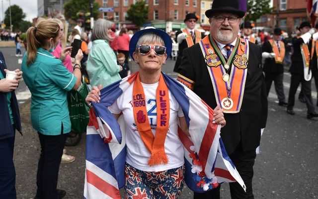 July 12, 2022: A supporter displays her flag and sash as the Twelfth of July orange march takes place in Belfast, Northern Ireland. 