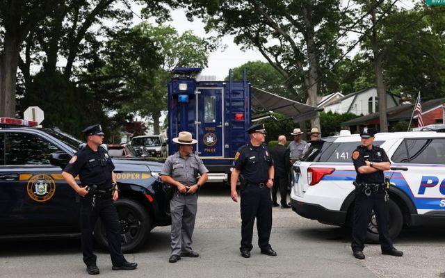 Law enforcement officials are seen as they investigate the home of a suspect arrested in the unsolved Gilgo Beach killings on July 14, 2023, in Massapequa Park, New York.