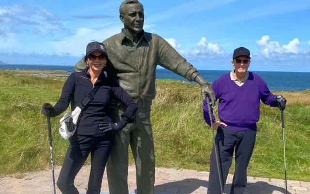 Catherine Zeta-Jones and Michael Douglas posing with the Arnold Palmer statue at Tralee Golf Club in Co Kerry.