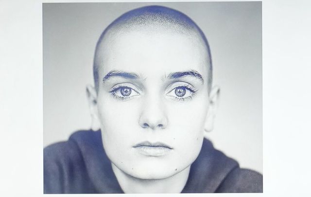 A photo of Sinead O\'Connor displayed at a memorial in London.