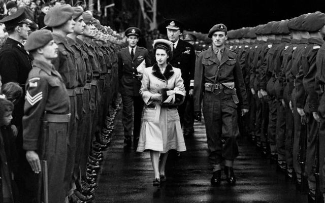 March 9, 1955: Princess Margaret Rose (1930 - 2002) walks through a guard of honour at Belfast.