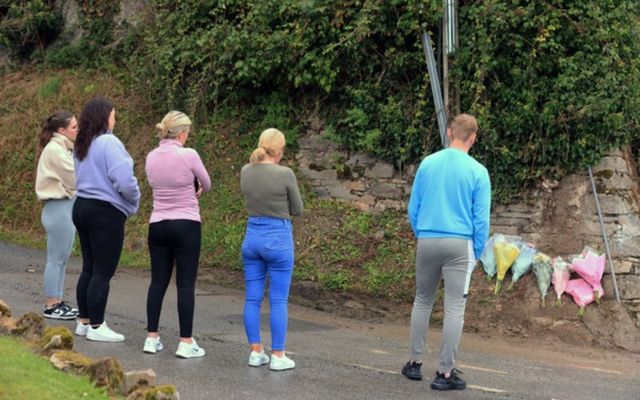  Grace McSweeney\'s boyfriend, Arron Costin, looks on after he and her friends lay flowers at the actual crash site on the Mountain Road in Clonmel Co Tipperary.