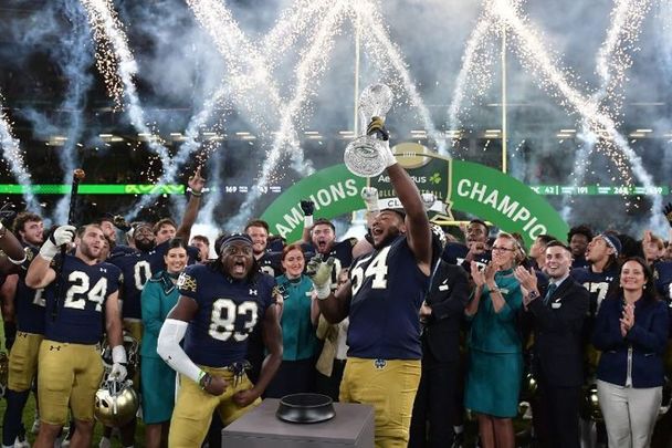August 26, 2023: Notre Dame players celebrate with the Aer Lingus trophy following the Aer Lingus College Football Classic game between Notre Dame and Navy at Aviva Stadium in Dublin, Ireland.