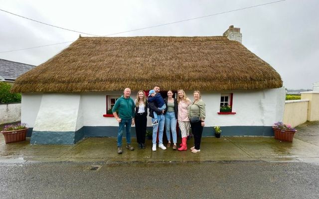 The Kealy-Dunne family outside their renovated cottage in Clogh Bridge, County Kilkenny. 