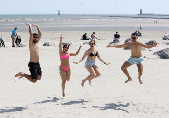 Yipee! Irish enjoy as Indian Summer, on Dollymount Beach, in Clontarf, Dublin.